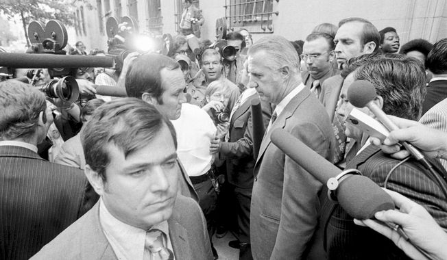 Spiro T. Agnew, who recently resigned from the vice presidency, talks a member of the media after he pleaded no contest to a federal tax evasion charge, outside the Federal Court building in Baltimore, Oct. 10, 1973. The last time Secret Service agents delivered a U.S. leader to face criminal charges, they kept their mission a secret, even from their own bosses. It was Oct. 10, 1973, and just a few agents knew the historic role they were playing in ensuring that Agnew appeared in a federal courtroom to enter a plea and resign from office. (AP Photo, File)