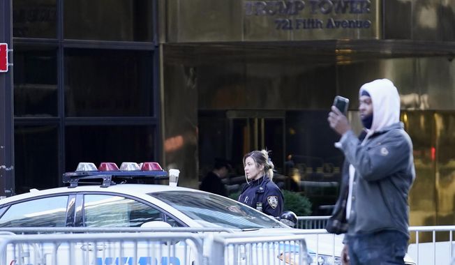 An NYPD officer blocks a street near Trump Tower, Monday, April 3, 2023 in New York. Former President Donald Trump is expected to travel to New York to face charges related to hush money payments. Trump is facing multiple charges of falsifying business records, including at least one felony offense, in the indictment handed up by a Manhattan grand jury. (AP Photo/Bryan Woolston)