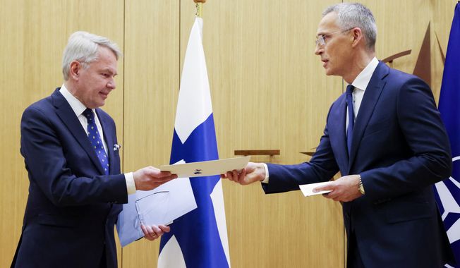 Finnish Foreign Minister Pekka Haavisto, left, hands over his nation&#x27;s accession document to NATO Secretary-General Jens Stoltenberg during a meeting of NATO foreign ministers at NATO headquarters in Brussels, Tuesday, April 4, 2023. Finland joined the NATO military alliance on Tuesday, dealing a major blow to Russia with a historic realignment of the continent triggered by Moscow&#x27;s invasion of Ukraine. (Johanna Geron, Pool Photo via AP)