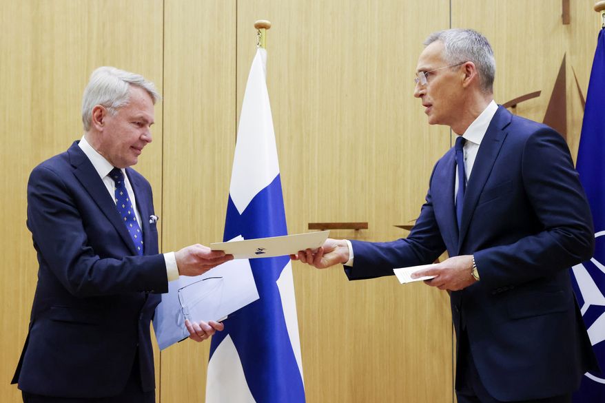 Finnish Foreign Minister Pekka Haavisto, left, hands over his nation's accession document to NATO Secretary-General Jens Stoltenberg during a meeting of NATO foreign ministers at NATO headquarters in Brussels, Tuesday, April 4, 2023. Finland joined the NATO military alliance on Tuesday, dealing a major blow to Russia with a historic realignment of the continent triggered by Moscow's invasion of Ukraine. (Johanna Geron, Pool Photo via AP)