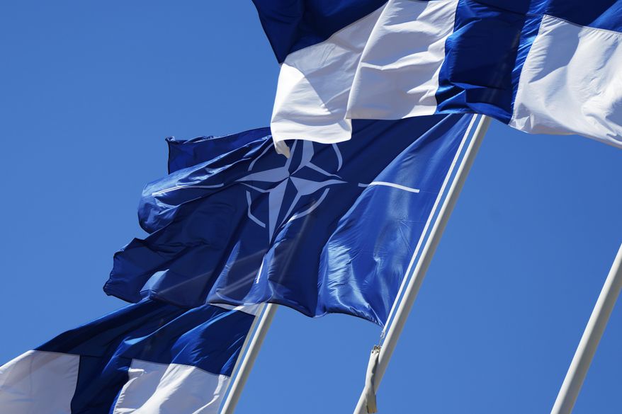 NATO and Finland flags flutter over the building of Ministry of Internal Affairs in Helsinki, Finland, Tuesday, April 4, 2023. Finland prepared to make its historic entry into NATO Tuesday, a step that doubles the Western alliance’s border with Russia and ends decades of non-alignment for the Nordic nation. (AP Photo/Sergei Grits)