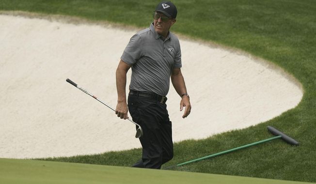 Phil Mickelson walks near the 13th green during a practice for the Masters golf tournament at Augusta National Golf Club, Tuesday, April 4, 2023, in Augusta, Ga. (AP Photo/Charlie Riedel)