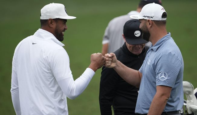 Tony Finau, left, speaks with Jon Rahm, of Spain, on the range during a practice for the Masters golf tournament at Augusta National Golf Club, Tuesday, April 4, 2023, in Augusta, Ga. (AP Photo/Matt Slocum)