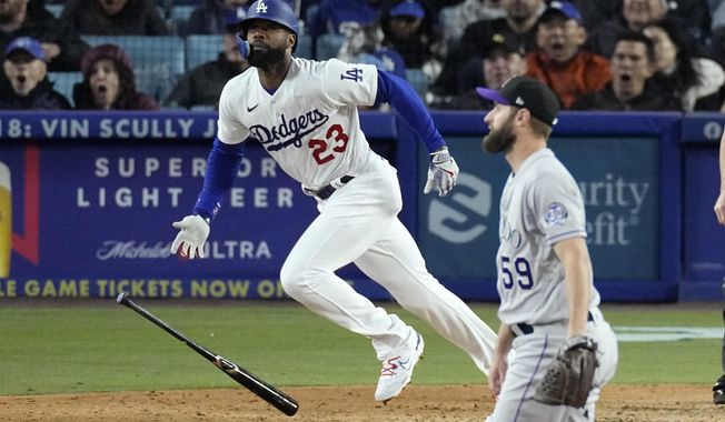 Los Angeles Dodgers&#x27; Jason Heyward, left, runs to first after hitting a two-run home run as Colorado Rockies relief pitcher Jake Bird watches during the fifth inning of a baseball game Monday, April 3, 2023, in Los Angeles. (AP Photo/Mark J. Terrill)