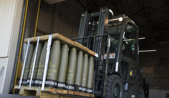 Airmen with the 436th Aerial Port Squadron use a forklift to move 155 mm shells ultimately bound for Ukraine, April 29, 2022, at Dover Air Force Base, Del. Officials say the U.S. will send Ukraine about $500 million in ammunition and equipment and will spend more than $2 billion to buy an array of munitions, radar and other weapons in the future. (AP Photo/Alex Brandon)
