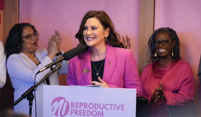 Michigan Gov. Gretchen Whitmer addresses supporters before signing legislation to repeal the 1931 abortion ban statute, which criminalized abortion in nearly all cases during a bill signing ceremony, Wednesday, April 5, 2023, in Birmingham, Mich. The abortion ban, which fueled one of the largest ballot drives in state history, had been unenforceable after voters enshrined abortion rights in the state constitution last November. (AP Photo/Carlos Osorio)
