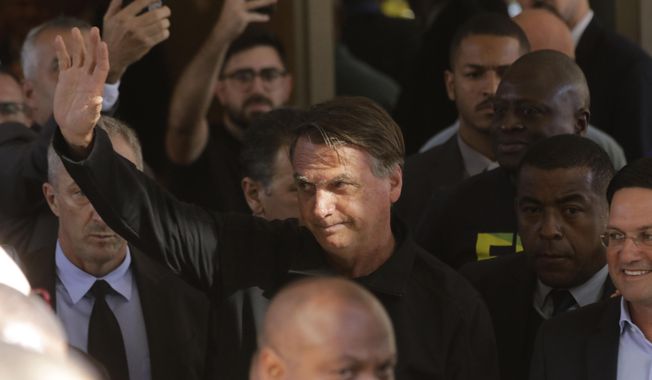 Brazil&#x27;s former President Jair Bolsonaro greets supporters outside the Liberal Party&#x27;s headquarters in Brasilia, Brazil, Thursday, March 30, 2023. Bolsonaro arrived back in Brazil on Thursday after a three-month stay in Florida. (AP Photo/Gustavo Moreno)