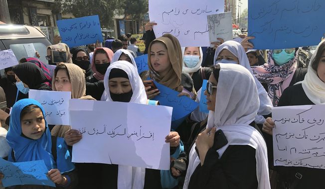 Afghan women chant and hold signs of protest during a demonstration in Kabul, Afghanistan, March 26, 2022. The U.N. said Wednesday, April 5, 2023, that it cannot accept a Taliban decision to bar Afghan female staffers from working at the agency, calling it an “unparalleled” violation of women&#x27;s rights. (AP Photo/Mohammed Shoaib Amin, File)