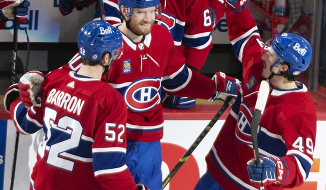 Montreal Canadiens&#x27; Joel Armia (40) celebrates after his goal against the Washington Capitals with teammates Justin Barron (52) and Rafael Harvey-Pinard (49) during second-period NHL hockey game action in Montreal, Thursday, April 6, 2023. (Peter McCabe/The Canadian Press via AP)