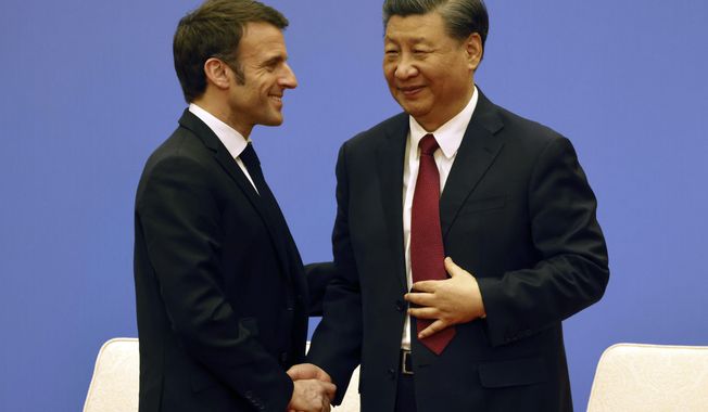 French President Emmanuel Macron, right, and Chinese President Xi Jinping take part in a Franco-Chinese business council meeting in Beijing, Thursday, April 6, 2023. (Ludovic Marin/Pool via AP)