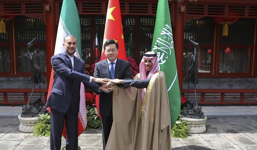 In this picture released by the Iranian Foreign Ministry, Iran&#x27;s Foreign Minister Hossein Amirabdollahian, left, shakes hands with his Saudi Arabian counterpart Prince Faisal bin Farhan Al Saud, right, and Chineses counterpart Qin Gang in Beijing Thursday, April 6, 2023. (Iranian Foreign Ministry via AP)