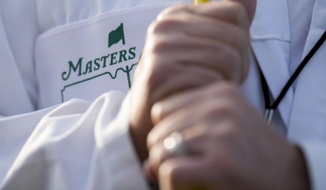 A forecaddie stands on the first hole during a practice round for the Masters golf tournament at Augusta National Golf Club on Wednesday, April 5, 2023, in Augusta, Ga. (AP Photo/Jae C. Hong)