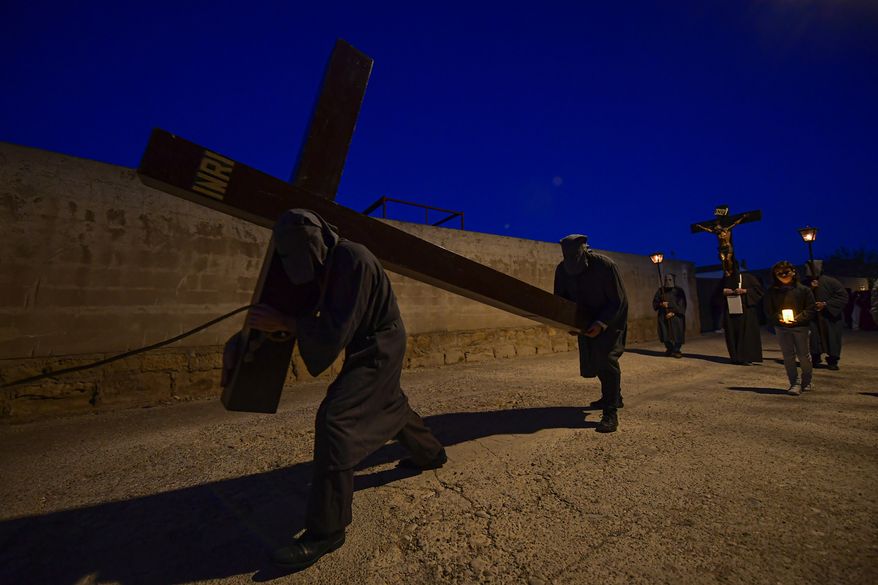 Penitents known as "Ensogado" brotherhood take part in a Holy Week procession in Sietamo, northern Spain, Thursday, April 6, 2023. (AP Photo/Alvaro Barrientos)
