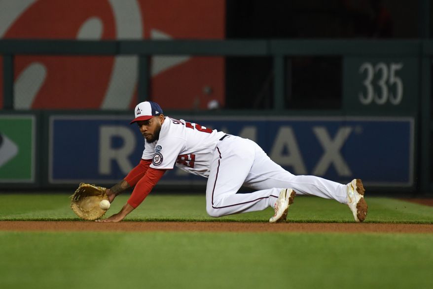 Washington Nationals first baseman Dominic Smith (22) diving to make a catch during an MLB game against the Tampa Bay Rays at Nationals Park in Washington D.C., April 3, 2023. (Photo by Billy Sabatini/All-Pro Reels)