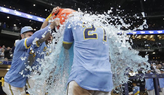 Milwaukee Brewers&#x27; Willy Adames is doused by teammates after the team&#x27;s baseball game against the St. Louis Cardinals on Friday, April 7, 2023, in Milwaukee. (AP Photo/Aaron Gash)