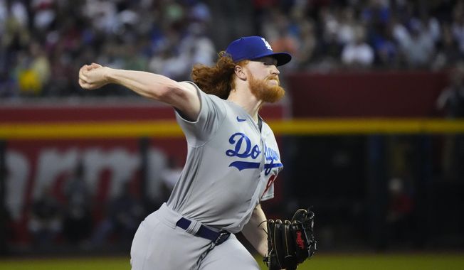 Los Angeles Dodgers starting pitcher Dustin May throws against the Arizona Diamondbacks during the first inning of a baseball game Thursday, April 6, 2023, in Phoenix. (AP Photo/Ross D. Franklin)