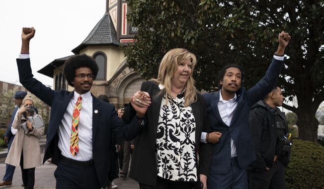 From left, expelled Rep. Justin Pearson, D-Memphis, Rep. Gloria Johnson, D-Knoxville, and expelled Rep. Justin Jones, D-Nashville, raise their fists as they walk across Fisk University campus after hearing Vice President Kamala Harris speak, Friday, April 7, 2023, in Nashville, Tenn. Harris came to support the two Democratic lawmakers, who were expelled from the Tennessee State Legislature. Jones was reinstated. (AP Photo/George Walker IV)