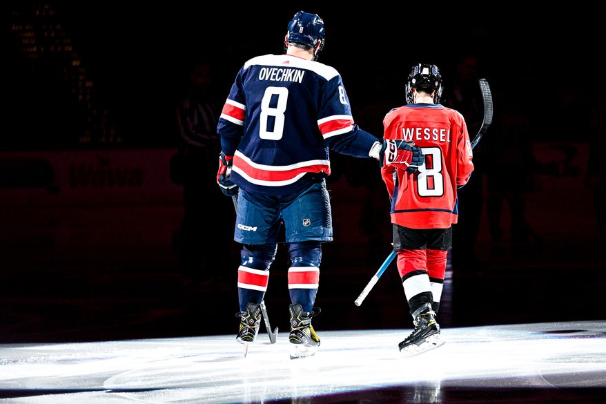Washington Capitals left wing Alex Ovechkin (8) puts an arm around Make-A-Wish recipient Nate Wessel, who served as an honorary captain against the New Jersey Devils at Capital One Arena, Washington, D.C., March 9, 2023. (Photo by Brian Murphy)