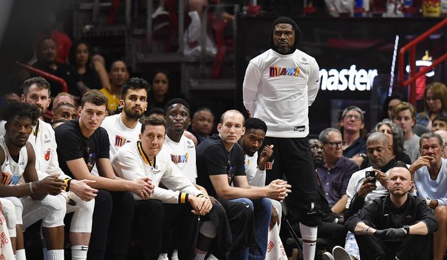 Miami Heat forward Udonis Haslem stands and watches his team play against the Brooklyn Nets during the second half of an NBA basketball game, Saturday, March 25, 2023, in Miami. (AP Photo/Michael Laughlin)