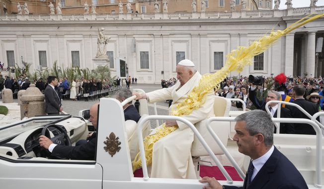 Pope Francis sits on the popemobile on his way to the altar to celebrate the Palm Sunday&#x27;s mass in St. Peter&#x27;s Square at The Vatican Sunday, April 2, 2023 a day after being discharged from the Agostino Gemelli University Hospital in Rome, where he has been treated for bronchitis, The Vatican said. The Roman Catholic Church enters Holy Week, retracing the story of the crucifixion of Jesus and his resurrection three days later on Easter Sunday. (AP Photo/Andrew Medichini)
