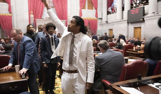 Former Rep. Justin Jones, D-Nashville, raises his fist on the floor of the House chamber as he walks to his desk to collect his belongings after being expelled from the legislature on Thursday, April 6, 2023, in Nashville, Tenn. Tennessee Republicans are seeking to oust three House Democrats including Jones for using a bullhorn to shout support for pro-gun control protesters in the House chamber. (AP Photo/George Walker IV)