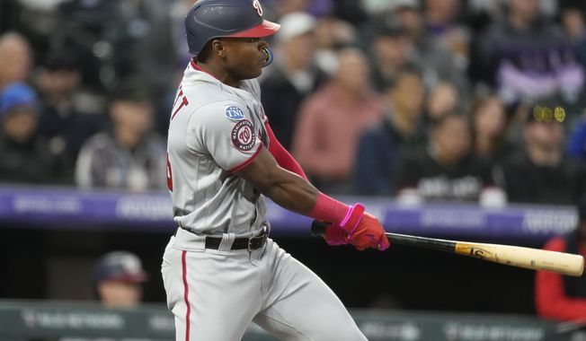 Washington Nationals&#x27; Stone Garrett follows the flight of his single to drive in two runs off Colorado Rockies starting pitcher Austin Gomber in the fifth inning of a baseball game Saturday, April 8, 2023, in Denver. (AP Photo/David Zalubowski)