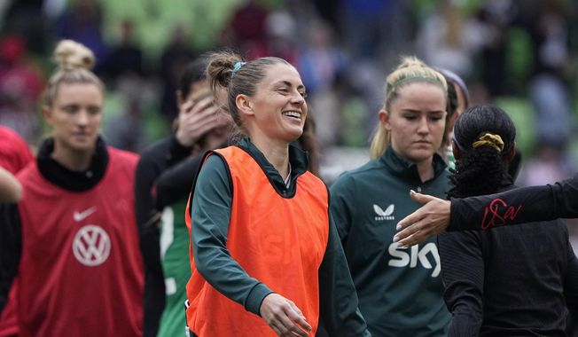 Republic of Ireland&#x27;s Sinead Farrelly, center, greets players after the team&#x27;s match with the United States in an international friendly soccer match in Austin, Texas, Saturday, April 8, 2023. Farrelly says she wouldn&#x27;t have been able to play soccer again if she hadn&#x27;t told her story. In 2021, Farrelly and teammate Mana Shim accused former National Women&#x27;s Soccer League coach Paul Riley of misconduct and sexual coercion in an article published by The Athletic. (AP Photo/Eric Gay, File) **file**