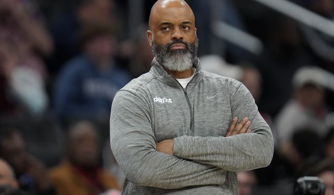 Washington Wizards head coach Wes Unseld Jr. looks on during the first half of an NBA basketball game against the Houston Rockets, Sunday, April 9, 2023, in Washington. (AP Photo/Jess Rapfogel)