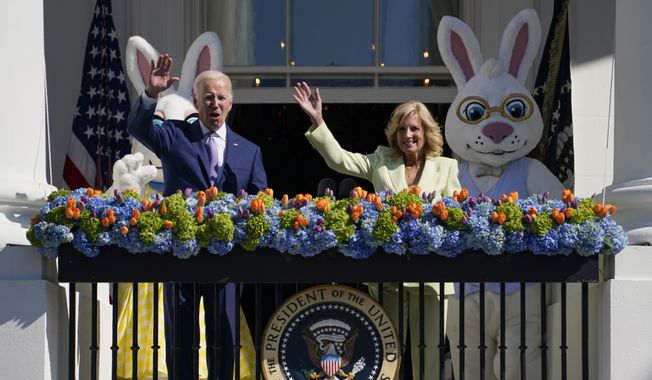 President Joe Biden and first lady Jill Biden wave from the Blue Room Balcony as they attend the 2023 White House Easter Egg Roll, Monday, April 10, 2023, in Washington. (AP Photo/Evan Vucci)