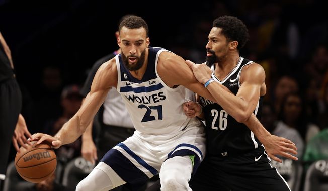 Minnesota Timberwolves center Rudy Gobert (27) drives to the basket against Brooklyn Nets guard Spencer Dinwiddie during the second half of an NBA basketball game, Tuesday, April 4, 2023, in New York. (AP Photo/Adam Hunger) **FILE**