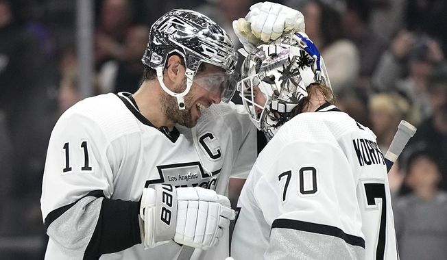 Los Angeles Kings center Anze Kopitar, left, and goaltender Joonas Korpisalo congratulate each other after the Kings defeated the Vancouver Canucks in an NHL hockey game Monday, April 10, 2023, in Los Angeles. (AP Photo/Mark J. Terrill)