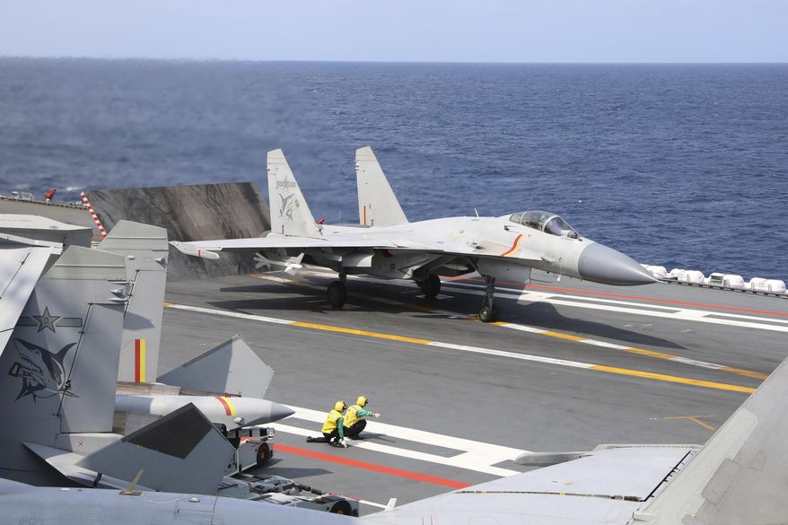 In this photo released by Xinhua News Agency, a J-15 Chinese fighter jet prepares to take off from the Shandong aircraft carrier during the combat readiness patrol and military exercises around the Taiwan Island by the Eastern Theater Command of the Chinese People's Liberation Army (PLA) on Sunday, April 9, 2023. China's military declared Monday it is "ready to fight" after completing three days of large-scale combat exercises around Taiwan that simulated sealing off the island in response to the Taiwanese president's trip to the U.S. last week. (An Ni/Xinhua via AP)