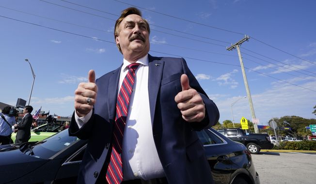 Mike Lindell gives a thumbs up as he stops by a rally for supporters of former President Donald Trump, Tuesday, April 4, 2023, in West Palm Beach, Fla. (AP Photo/Wilfredo Lee)