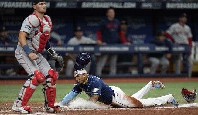 Tampa Bay Rays&#x27; Wander Franco scores in front of Boston Red Sox catcher Reese McGuire on a sacrifice fly by Randy Arozarena during the eighth inning of a baseball game Wednesday, April 12, 2023, in St. Petersburg, Fla. (AP Photo/Chris O&#x27;Meara)