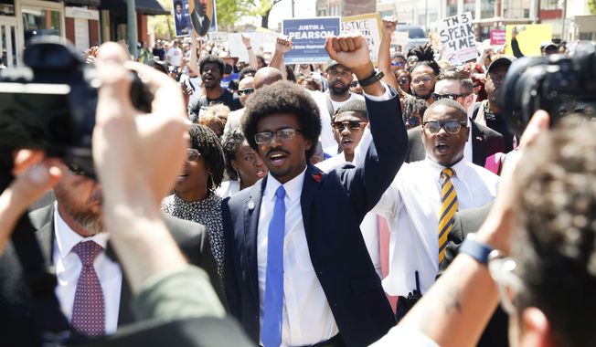 Justin Pearson and his supporters march to the Shelby County Board of Commissioners meeting in Memphis, Tenn., on Wednesday, April 12, 2023, where it is expected Pearson will be reinstated to his position in the Tennessee House of Representatives. (Chris Day /The Commercial Appeal via AP)