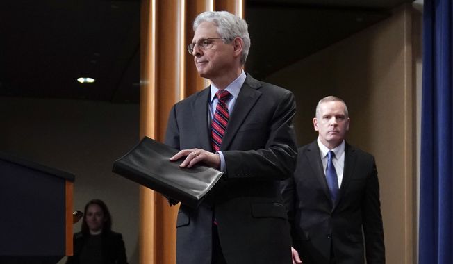 Attorney General Merrick Garland arrives to speak at the Department of Justice in Washington, Thursday, April 13, 2023. Garland announced that a Massachusetts Air National Guard member who has emerged as a main person of interest in the disclosure of highly classified military documents on the Ukraine war was taken into custody Thursday by federal agents. FBI Deputy Director Paul Abbate follows at right. (AP Photo/Evan Vucci)