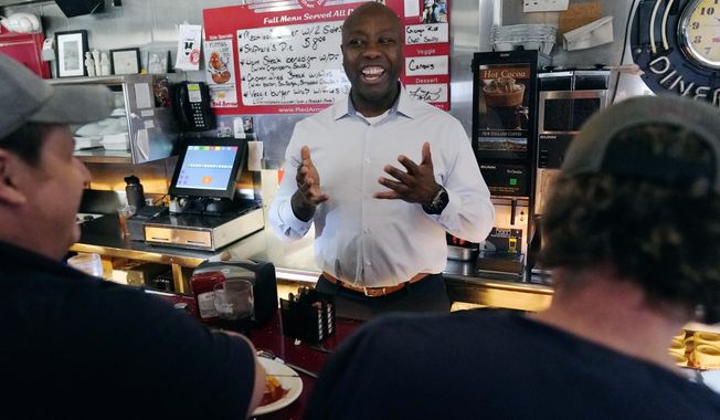 Sen. Tim Scott, R-S.C., talks with diners at the breakfast counter during a visit to the Red Arrow Diner, Thursday, April 13, 2023, in Manchester, N.H. Scott on Wednesday launched an exploratory committee for a 2024 GOP presidential bid, a step that comes just shy of making his campaign official. (AP Photo/Charles Krupa)