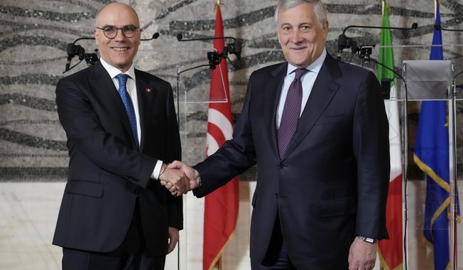 Tunisia&#x27;s Foreign Affairs Minister Nabil Ammar left and Italy&#x27;s Foreign Minister Antonio Tajani shakes hands for photographers at La Farnesina Foreign Minister headquarters in Rome, Thursday, April 13, 2023. (AP Photo/Andrew Medichini)