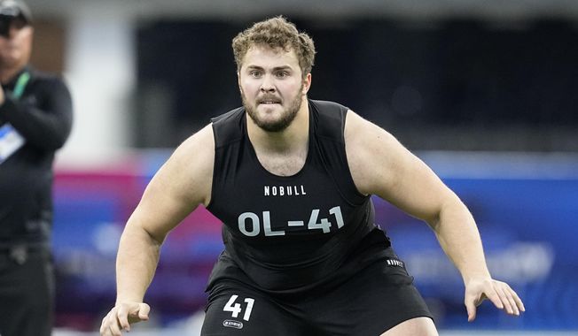 Northwestern offensive lineman Peter Skoronski runs a drill at the NFL football scouting combine in Indianapolis, Sunday, March 5, 2023. Skoronski looks like a custom-built NFL offensive lineman. (AP Photo/Darron Cummings, File)