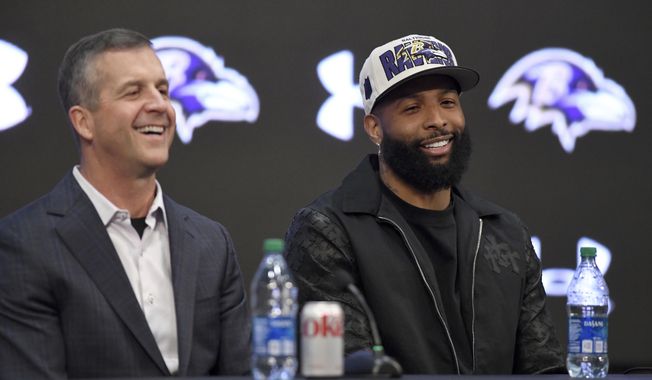Recently signed Baltimore Ravens NFL football wide receiver Odell Beckham Jr., right, sits with head coach John Harbaugh, during a news conference at the team&#x27;s practice facility in Owings Mills, Md., on Thursday, April 13, 2023. (AP Photo/Steve Ruark)