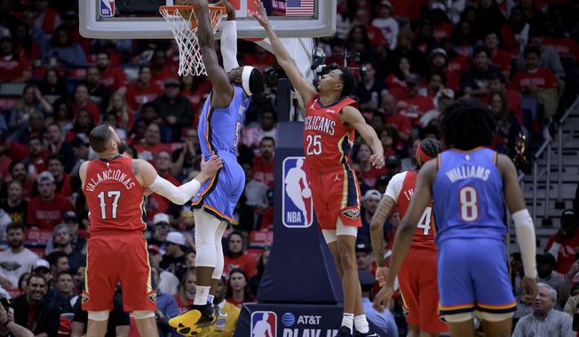 Oklahoma City Thunder guard Luguentz Dort (5) dunks against New Orleans Pelicans guard Trey Murphy III (25) during the first half of an NBA basketball play-in tournament game in New Orleans, Wednesday, April 12, 2023. (AP Photo/Matthew Hinton)