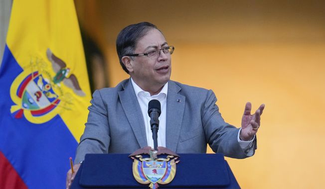 Colombian President Gustavo Petro speaks to supporters before presenting to Congress a proposed bill to reform the healthcare system, outside the Nariño presidential palace in Bogota, Colombia, Monday, Feb. 13, 2023. President Joe Biden is hosting Colombian President Gustavo Petro at the White House for talks next week. (AP Photo/Fernando Vergara, File)