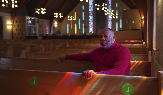 The Rev. Dale Snyder sits in the pews at Bethel AME Church where he is pastor, in Pittsburgh on Tuesday, April 11, 2023. Bethel, considered Pittsburgh's oldest Black congregation, lost its previous sanctuary when much of Pittsburgh's historic Lower Hill District was razed in the 1950s, making way for an arena and expressway in an urban renewal project. More than 60 years later, in what's being called a step toward "restorative justice," the church is poised to obtain use of a 1.5-acre parcel near its former site in an agreement with the Pittsburgh Penguins. (AP Photo/Jessie Wardarski)