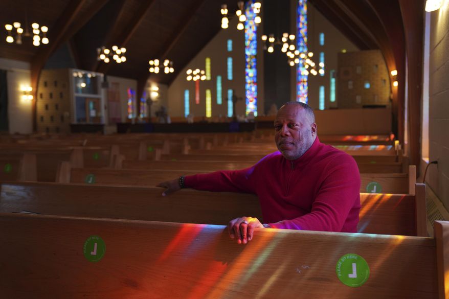 The Rev. Dale Snyder sits in the pews at Bethel AME Church where he is pastor, in Pittsburgh on Tuesday, April 11, 2023. Bethel, considered Pittsburgh's oldest Black congregation, lost its previous sanctuary when much of Pittsburgh's historic Lower Hill District was razed in the 1950s, making way for an arena and expressway in an urban renewal project. More than 60 years later, in what's being called a step toward "restorative justice," the church is poised to obtain use of a 1.5-acre parcel near its former site in an agreement with the Pittsburgh Penguins. (AP Photo/Jessie Wardarski)
