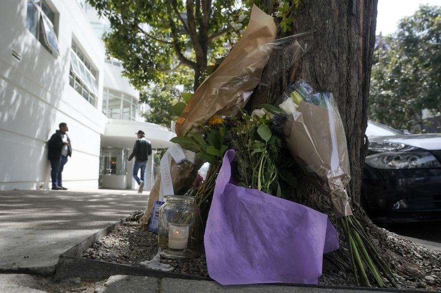 Flowers sit at a tree in front of the building where a technology executive was fatally stabbed outside of in San Francisco, Thursday, April 6, 2023. The 38-year-old tech consultant charged in the stabbing death of Cash App founder Bob Lee made his first appearance in a San Francisco courtroom Friday, April 14, but did not enter a plea. (AP Photo/Jeff Chiu, File)