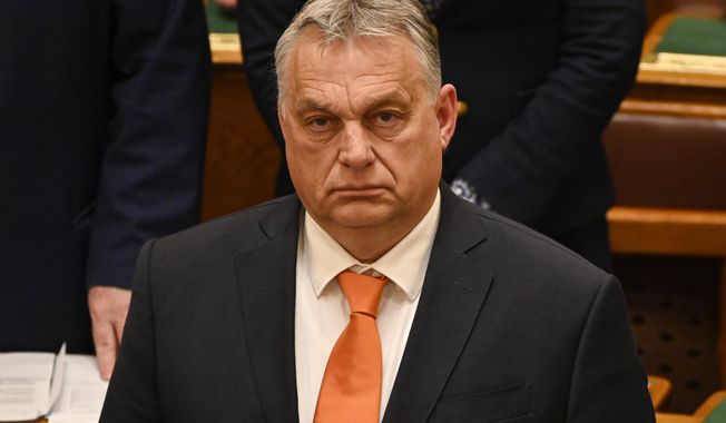 Hungary&#x27;s Prime Minister Viktor Orban stands after a vote on Finland&#x27;s bid to join NATO, at the parliament in Budapest, Hungary, on March 27, 2023.  Hungary&#x27;s prime minister sought to bring down the temperature on spiraling tensions between his government and the United States, declaring Friday, April 14, 2023, that the U.S. is Hungary&#x27;s “friend” despite sanctions Washington imposed on a Budapest-based Russian bank. (AP Photo/Denes Erdos, File)