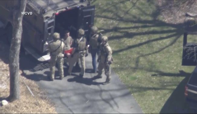 This image made from video provided by WCVB-TV, shows Jack Teixeira, in T-shirt and shorts, being taken into custody by armed tactical agents on Thursday, April 13, 2023, in Dighton, Mass. (WCVB-TV via AP) ** FILE **