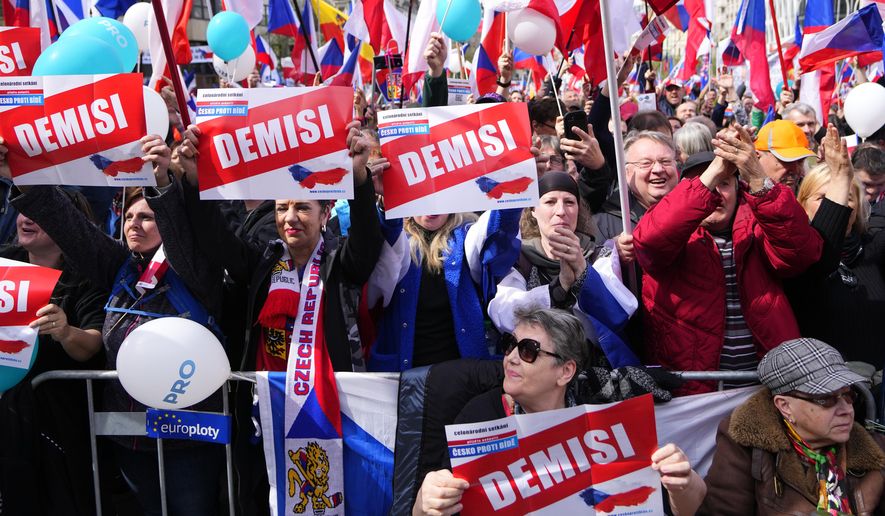 People shout slogans as thousands of people gather to protest high inflation and to demand the government's resignation in Prague, Czech Republic, Sunday, April 16, 2023. (AP Photo/Petr David Josek)