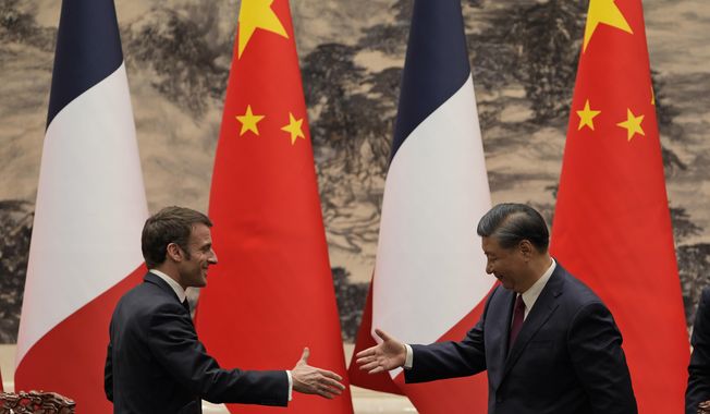 French President Emmanuel Macron, left, shakes hands with Chinese President Xi Jinping after meeting the press at the Great Hall of the People in Beijing, on April 6, 2023. In the weeks since Chinese leader Xi Jinping won a third five-year term as president, setting him on course to remain in power for life, leaders and diplomats from around the world have beaten a path to his door. None more so than those from Europe. (AP Photo/Ng Han Guan, Pool, File)
