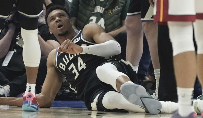 Milwaukee Bucks&#x27; Giannis Antetokounmpo lays on the ground after an injury during the first half in Game 1 of an NBA basketball first-round playoff game Sunday, April 16, 2023, in Milwaukee. (AP Photo/Morry Gash)